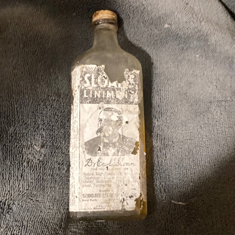 Bottle of Sloan’s Liniment, vintage with partial label and liquid